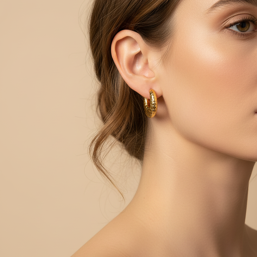 Model wearing Mara Hoops quilted gold hoop earrings – chunky earrings with crescent hoop earrings silhouette, hypoallergenic earrings, stainless steel earrings