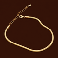 Ari Anklet gold snake chain herringbone anklet on dark background – minimal flat chain stainless steel anklet for women, non-tarnish and hypoallergenic