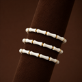 Bambi Bracelet set of three white bamboo bead bracelets with gold accents on display stand – stretch bracelet stack, non-tarnish waterproof hypoallergenic women's bracelet