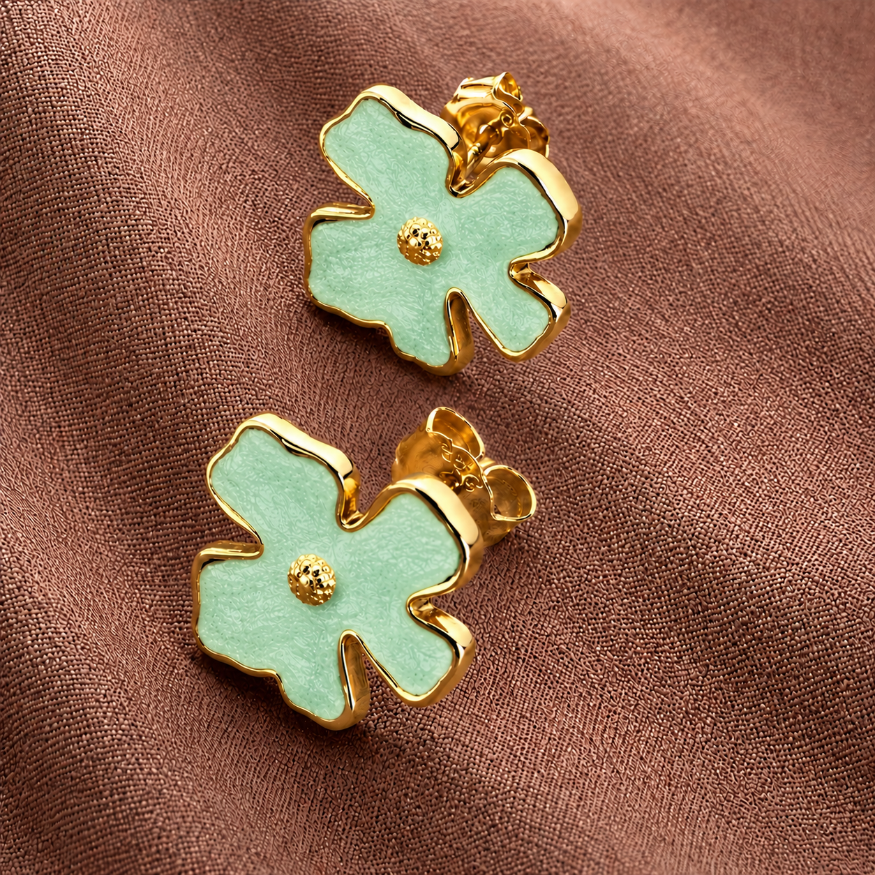 Bloomie Studs mint green enamel flower stud earrings with gold wavy border and textured gold centre on warm fabric – hypoallergenic nickel-free non-allergic stainless steel floral stud earrings