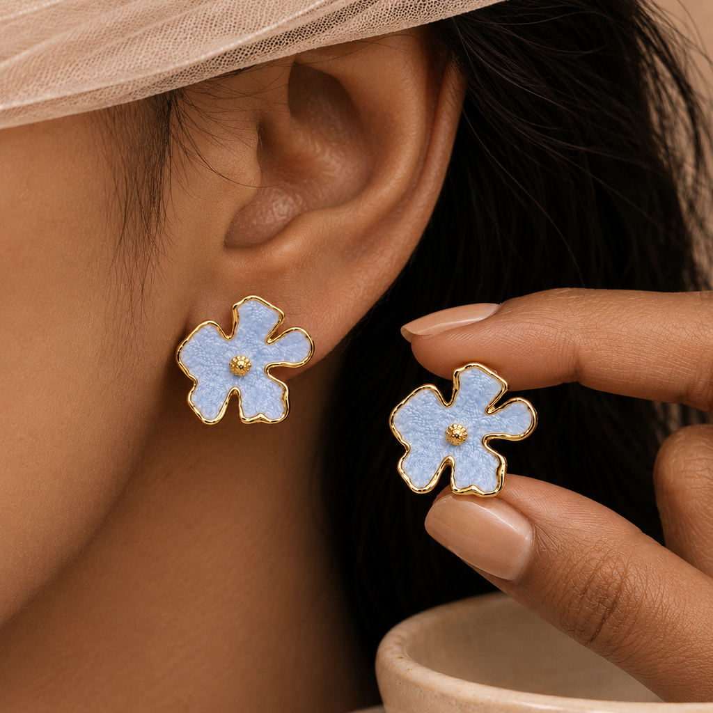 Bloomie Studs sky blue pastel enamel floral stud earrings worn and held by model – hypoallergenic non-tarnish nickel-free stainless steel flower stud earrings gift idea for women
