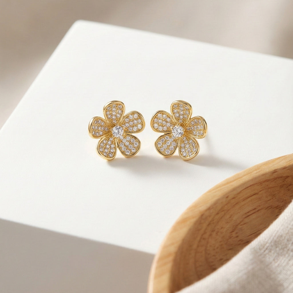 Daeze Studs gold pavé cubic zirconia flower stud earrings with CZ solitaire centre on white display block – surgical steel earrings for sensitive ears that don't tarnish