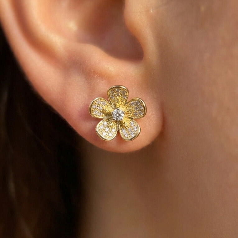 Daeze Studs gold pavé flower stud earrings with cubic zirconia petals and CZ centre worn by model – hypoallergenic surgical steel zirconia earrings for sensitive ears