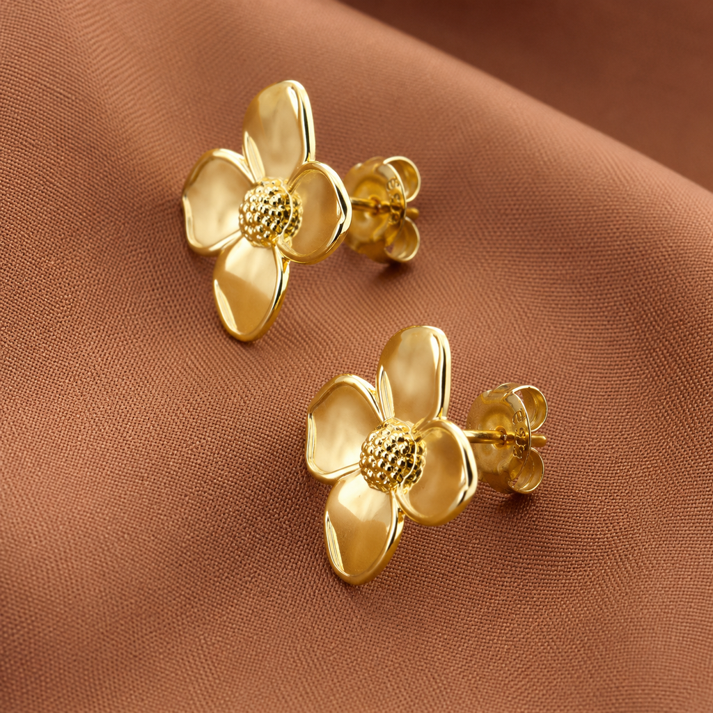 Dalia Studs polished gold flower stud earrings with four sculptural petals and textured gold centre on warm fabric – hypoallergenic non-tarnish stainless steel gold earrings