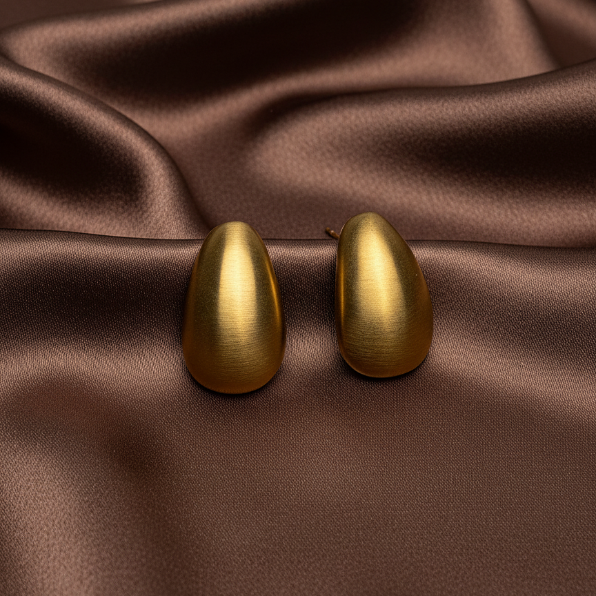 Elara Studs brushed gold teardrop dome earrings on dark brown satin fabric – chunky hypoallergenic waterproof stainless steel stud earrings capsule jewellery