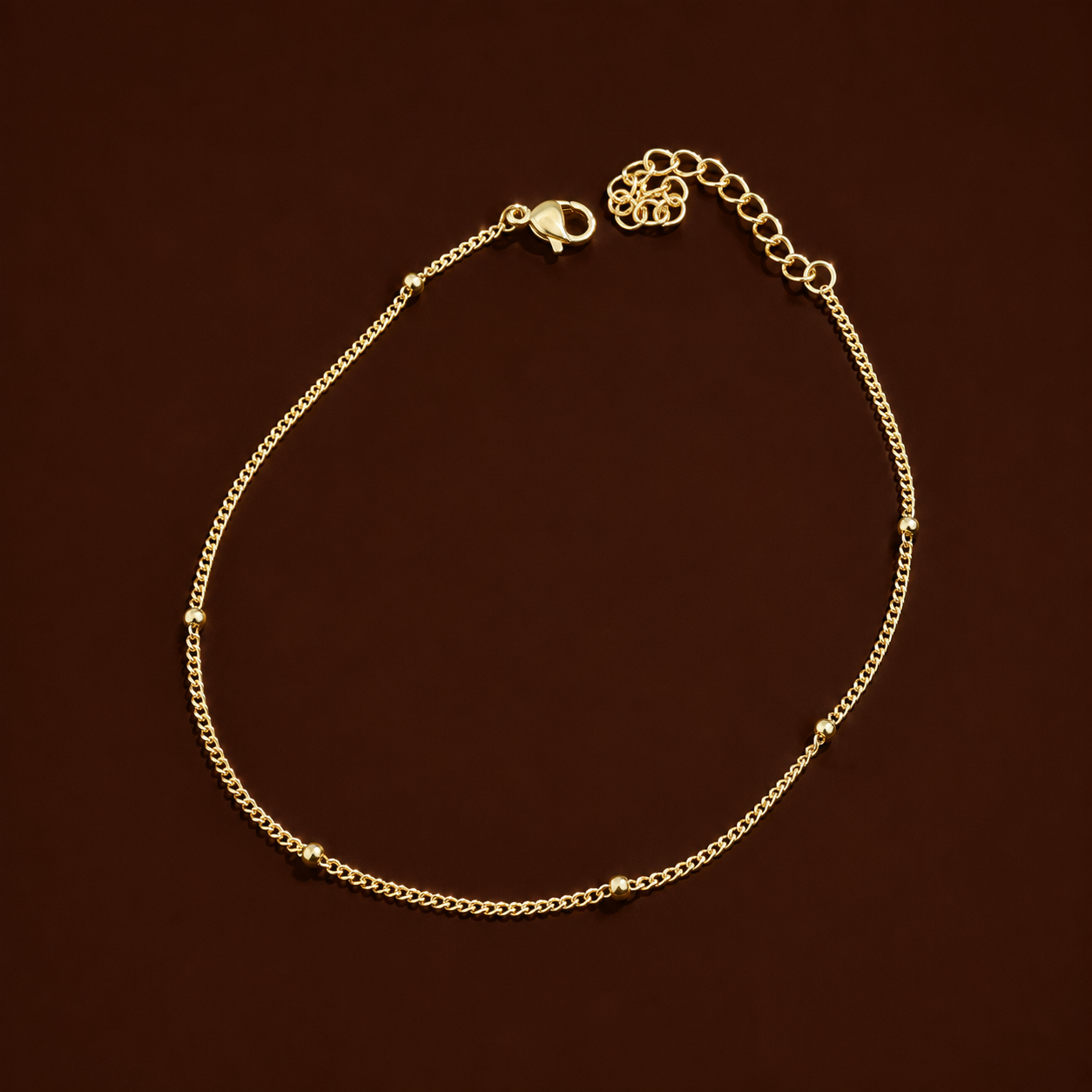 Elia Anklet gold satellite chain anklet on dark background – dainty stainless steel gold ankle bracelet, non-tarnish and hypoallergenic for women