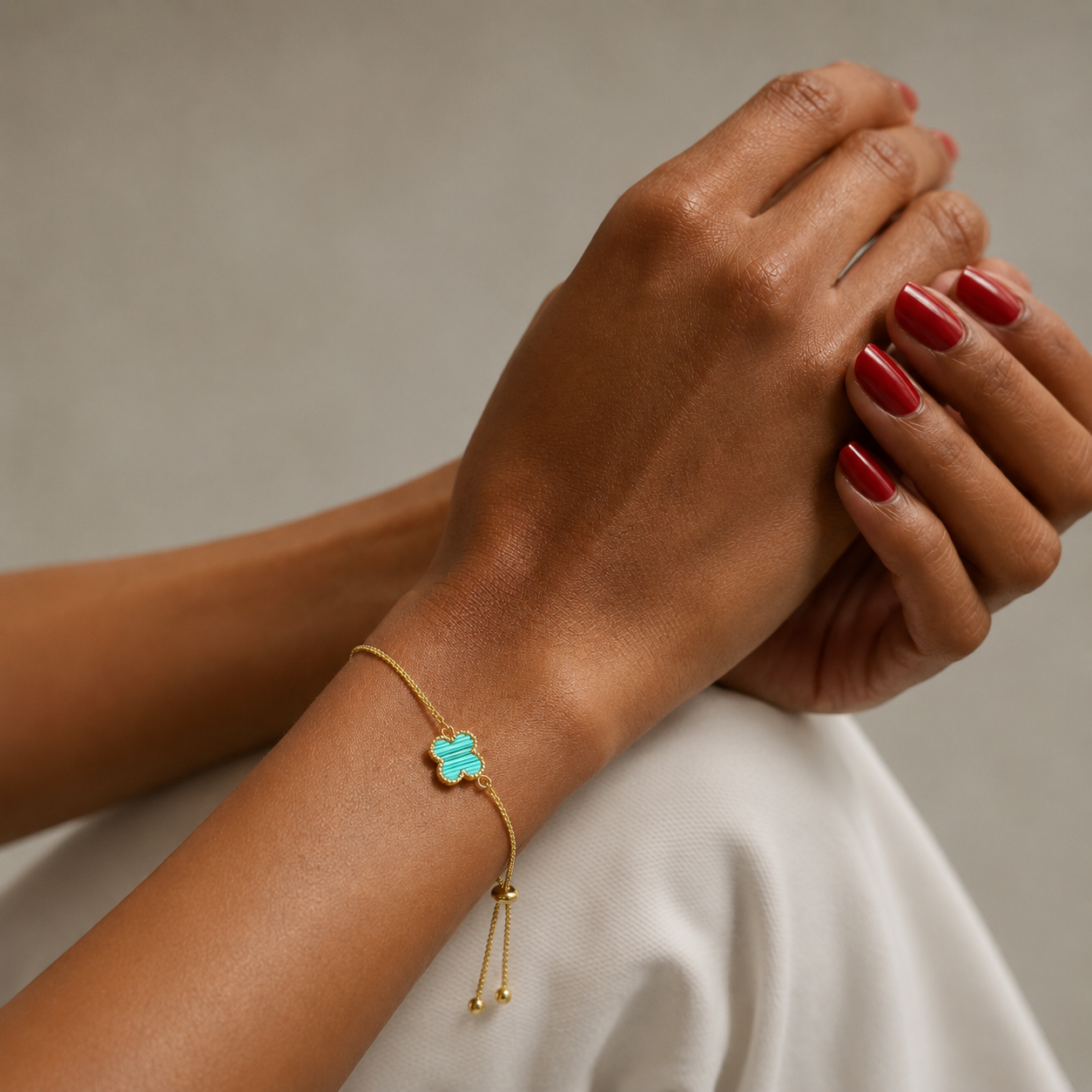 Fleur Bracelet teal lucky clover bracelet on wrist – adjustable gold clover bracelet, waterproof stainless steel hypoallergenic UK jewellery