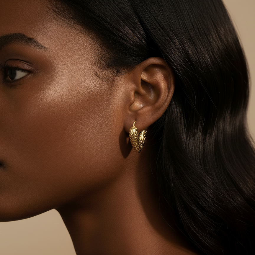 Lani Hoops chunky hammered gold heart hoop earrings with textured pitted surface worn by model – hypoallergenic non-tarnish stainless steel gold hoop earrings