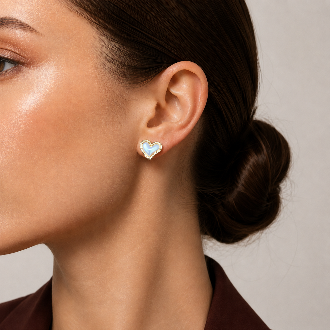 Mio Studs sky blue mother of pearl heart stud earrings with hammered gold border worn by model – hypoallergenic nickel-free non-tarnish stainless steel gold heart earrings gift for women
