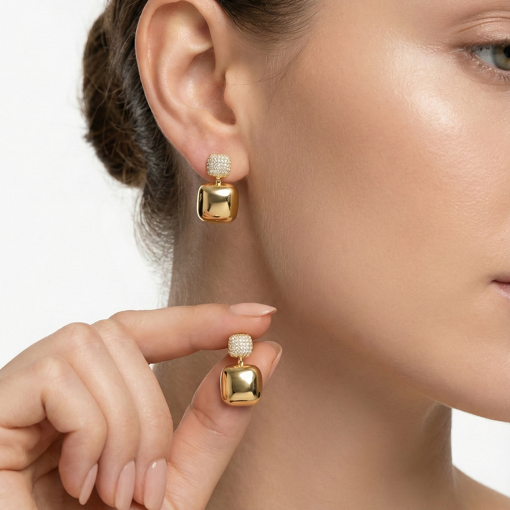 Nanya Drops pavé cubic zirconia and gold square drop earrings worn and held by model – hypoallergenic stainless steel cz drop earrings for sensitive ears