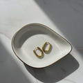 Nné Hoops gold huggie hoop earrings with sleek round silhouette worn by model – everyday minimalist stainless steel gold hoop earrings