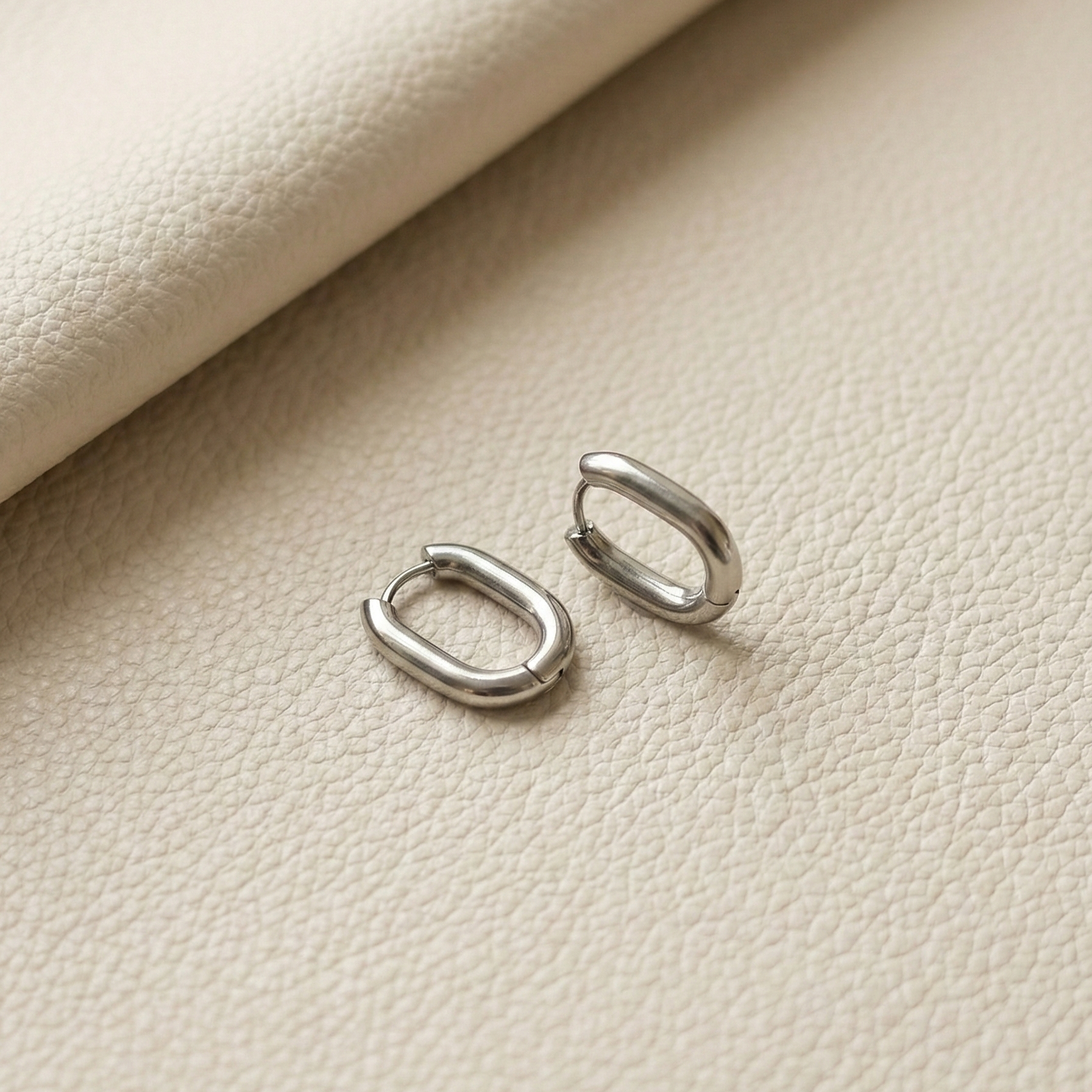 Nné Hoops silver oval hoop earrings with architectural rectangular curve – waterproof non-tarnish stainless steel huggie earrings