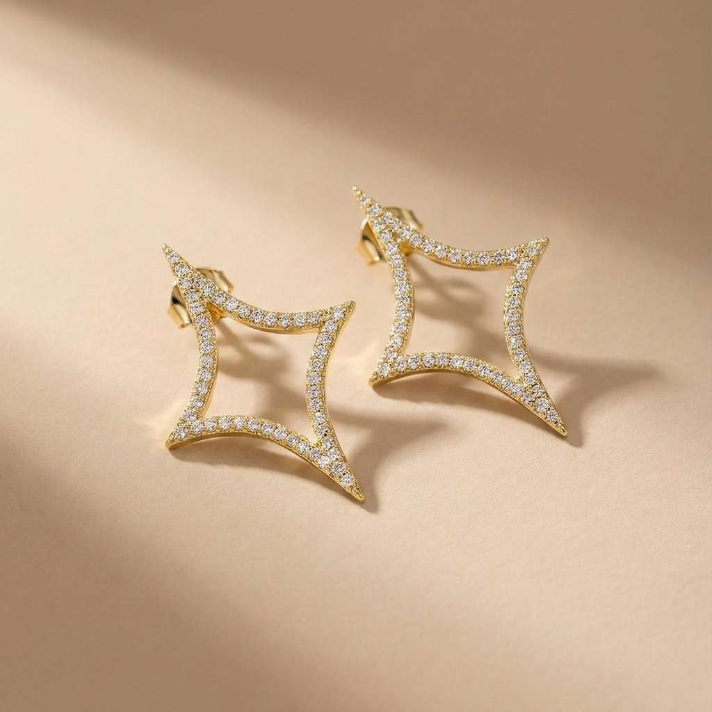 Nova Studs gold pavé sparkle star stud earrings on beige background – cubic zirconia statement stud earrings in tarnish free waterproof surgical steel