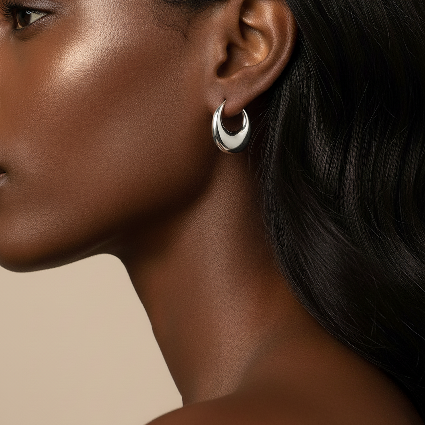 Onyx Hoops chunky silver hoop earrings with tapered crescent silhouette and high-mirror polish worn by model – hypoallergenic non-tarnish sterling silver hoop earrings UK