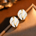Riva Studs white and gold enamel swirl oval stud earrings with bold wave detail – hypoallergenic nickel-free stainless steel everyday earrings for sensitive ears