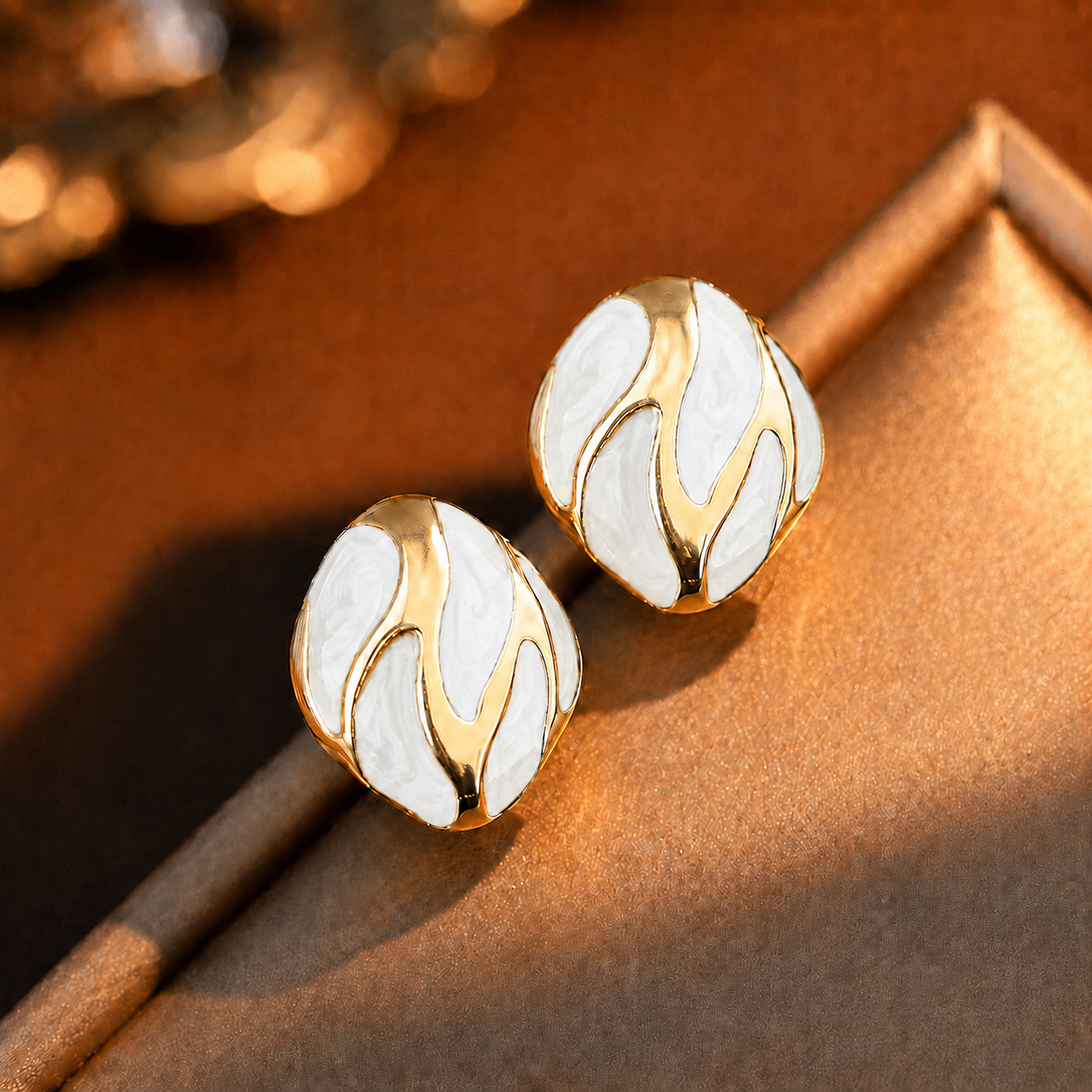 Riva Studs white and gold enamel swirl oval stud earrings with bold wave detail – hypoallergenic nickel-free stainless steel everyday earrings for sensitive ears