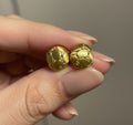Wendy Studs brushed matte gold dome stud earrings with quilted texture and crystal detail held between fingers – hypoallergenic non-tarnish waterproof stainless steel brushed gold earrings